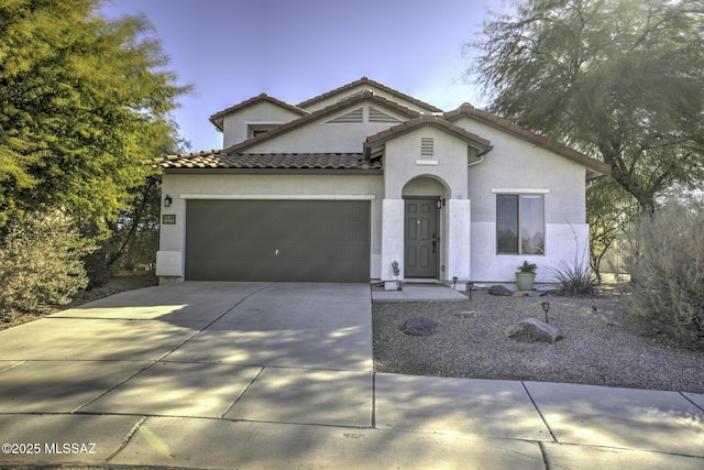 mediterranean / spanish home featuring a garage