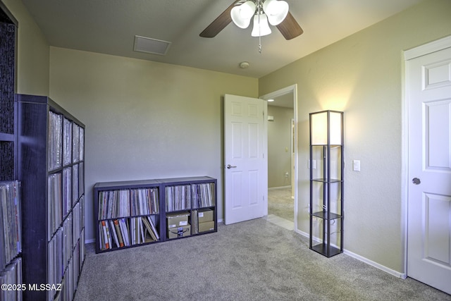 spare room with ceiling fan and carpet