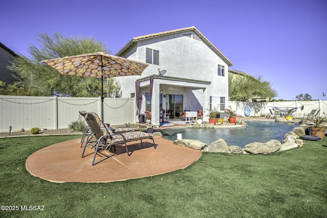 back of house featuring a fenced in pool, a patio, and a yard