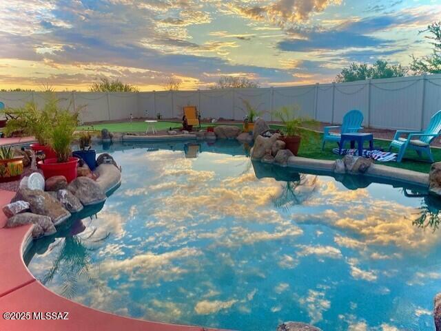 view of pool at dusk