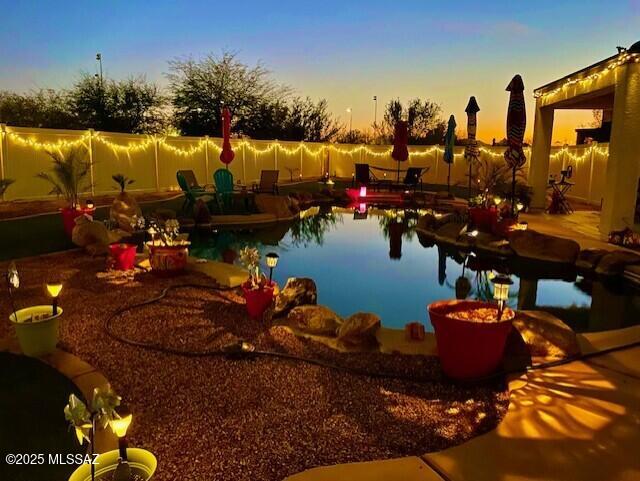 view of pool at dusk