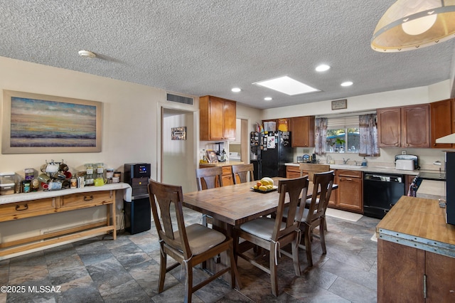 dining space featuring a textured ceiling