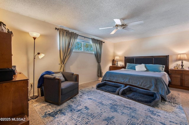 carpeted bedroom featuring ceiling fan and a textured ceiling