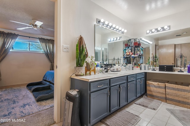 bathroom featuring a textured ceiling, ceiling fan, tile patterned flooring, and vanity