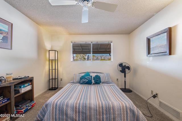 bedroom featuring ceiling fan, carpet, and a textured ceiling