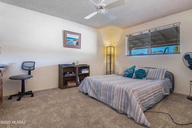 bedroom featuring ceiling fan, a textured ceiling, and carpet flooring