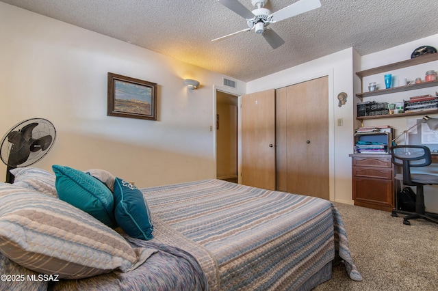 bedroom with ceiling fan, carpet, a closet, and a textured ceiling