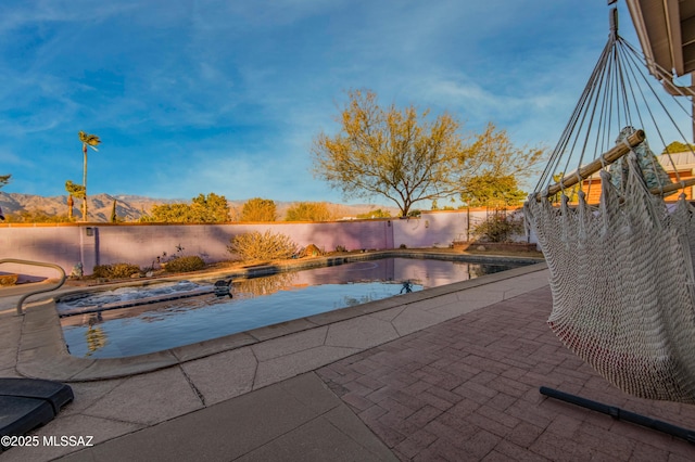 view of pool with a patio area and a mountain view