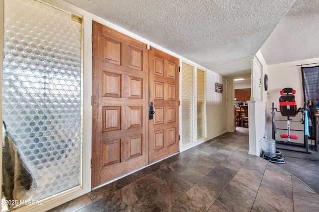 foyer with a textured ceiling