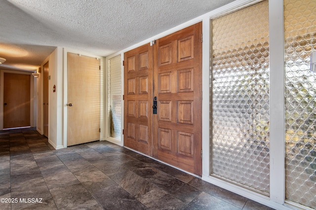 entryway with a textured ceiling