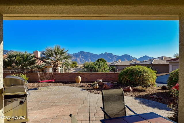 view of patio / terrace with a mountain view and grilling area