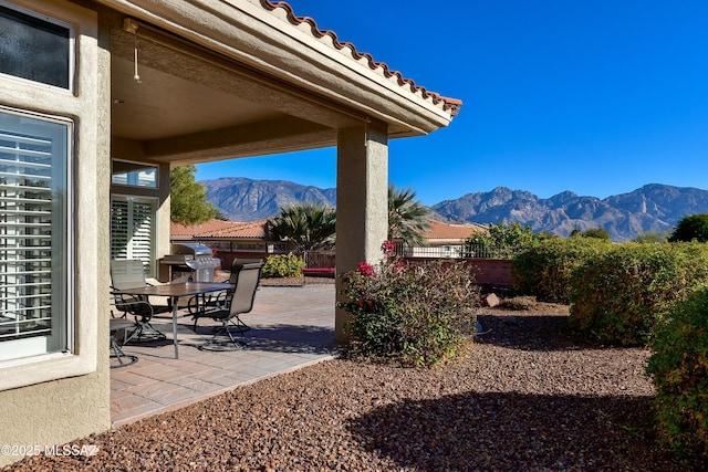 view of patio / terrace with a mountain view and grilling area