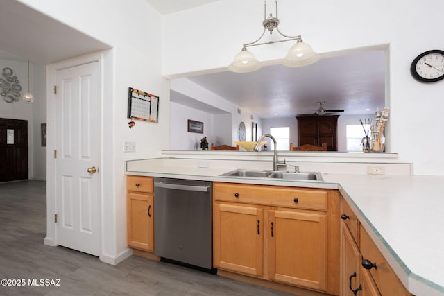 kitchen featuring sink, decorative light fixtures, light hardwood / wood-style floors, and dishwasher