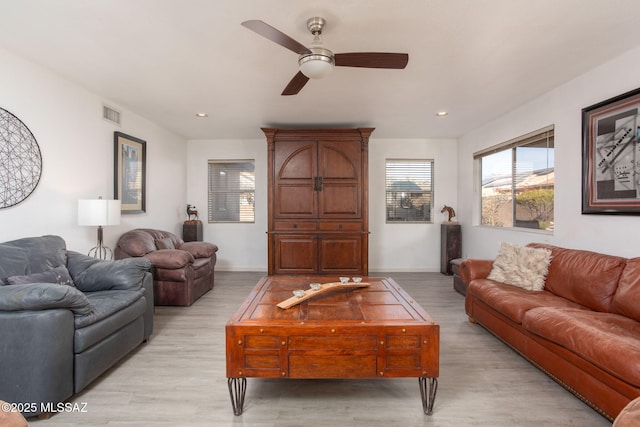 living room with ceiling fan and light wood-type flooring