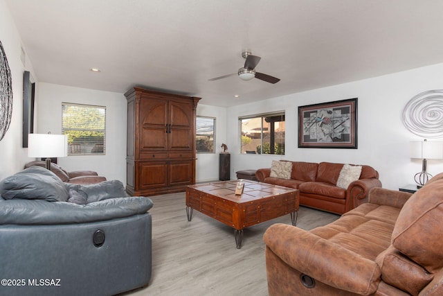 living room with ceiling fan and light hardwood / wood-style flooring