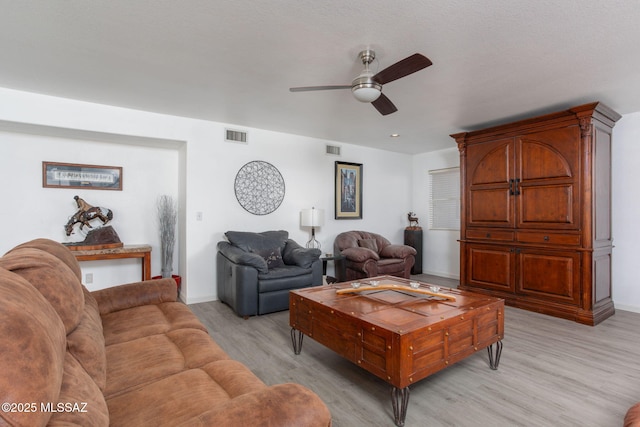 living room featuring ceiling fan and light hardwood / wood-style floors