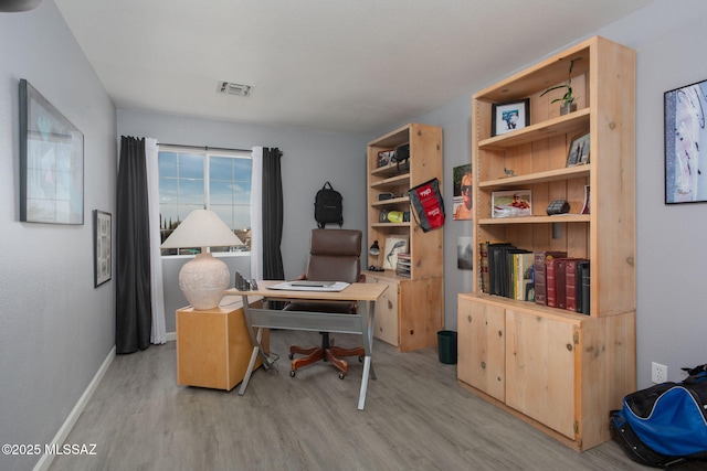 office space with light wood-type flooring