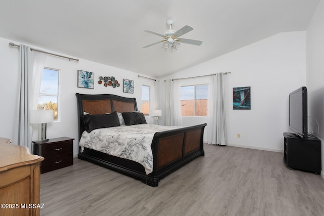 bedroom with ceiling fan, lofted ceiling, and light hardwood / wood-style floors