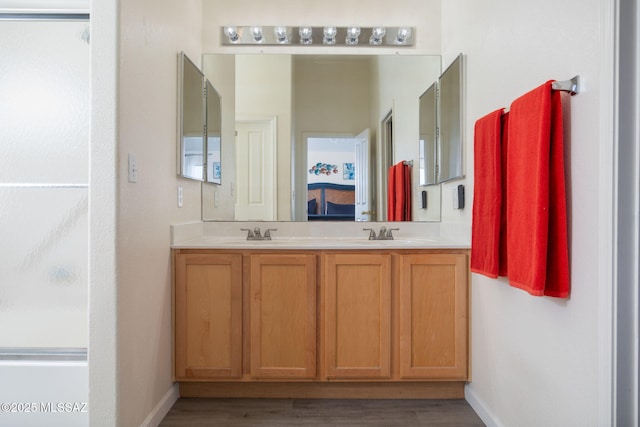 bathroom featuring hardwood / wood-style flooring and vanity