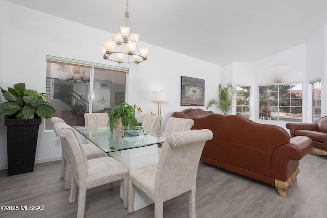 dining space featuring a chandelier and light hardwood / wood-style flooring