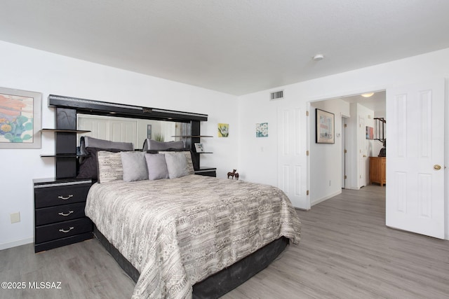 bedroom with light wood-type flooring