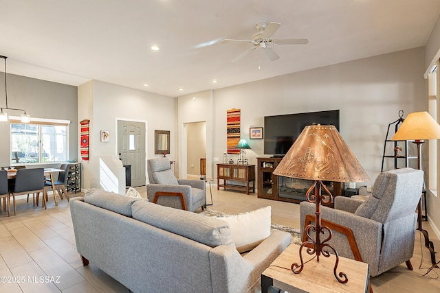 living room featuring ceiling fan and light hardwood / wood-style flooring