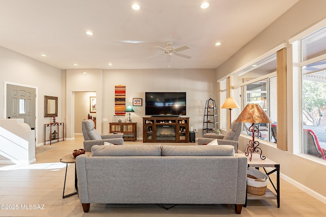 living room with ceiling fan and light hardwood / wood-style floors