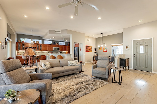 living room with ceiling fan and light wood-type flooring