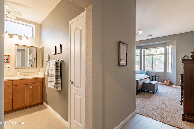 bathroom featuring wood-type flooring, vanity, and ceiling fan