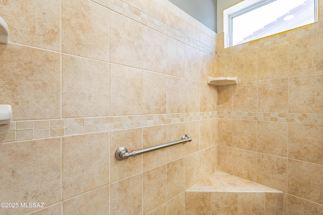 bathroom with a tile shower