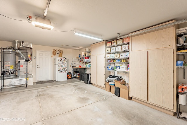 garage featuring a workshop area and gas water heater