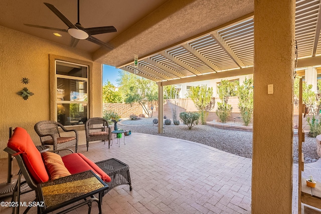 view of patio / terrace with ceiling fan and a pergola