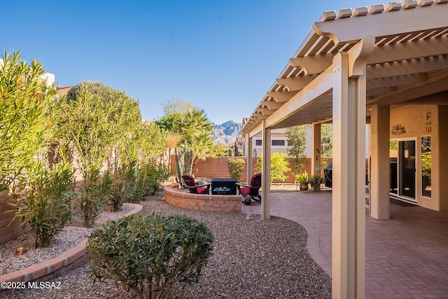 view of yard featuring a patio, a mountain view, and a pergola