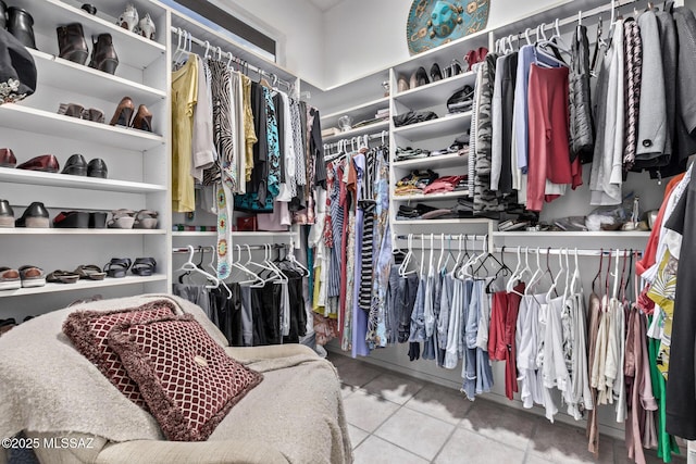 walk in closet with tile patterned floors