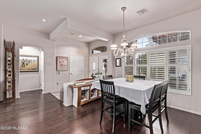 dining area with a notable chandelier and dark hardwood / wood-style floors