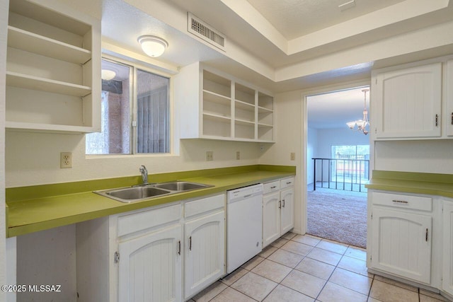 kitchen with sink, white cabinetry, white dishwasher, a notable chandelier, and light colored carpet