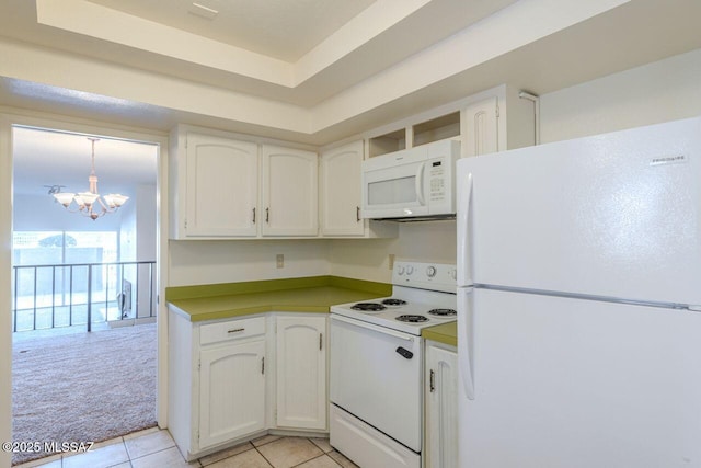 kitchen with decorative light fixtures, white cabinetry, a raised ceiling, light carpet, and white appliances