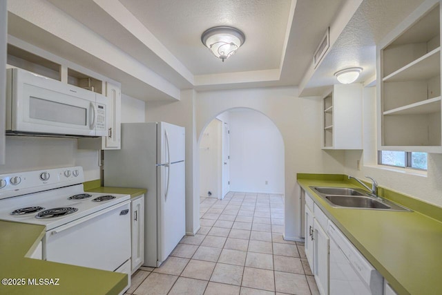 kitchen featuring sink, white appliances, light tile patterned floors, a textured ceiling, and white cabinets