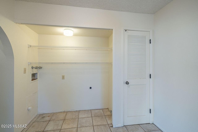 clothes washing area with washer hookup, hookup for an electric dryer, and a textured ceiling