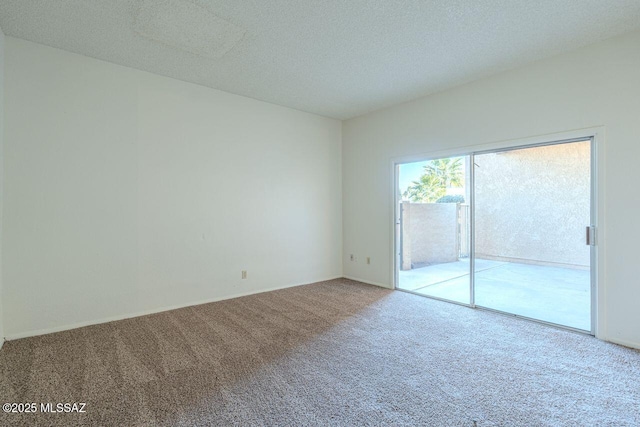 carpeted spare room with a textured ceiling