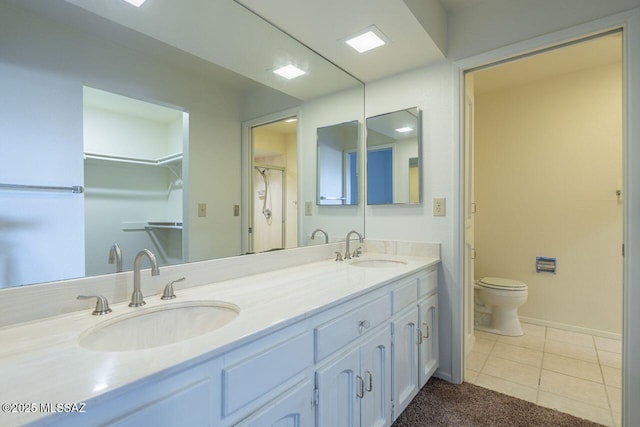 bathroom with vanity, toilet, and tile patterned flooring