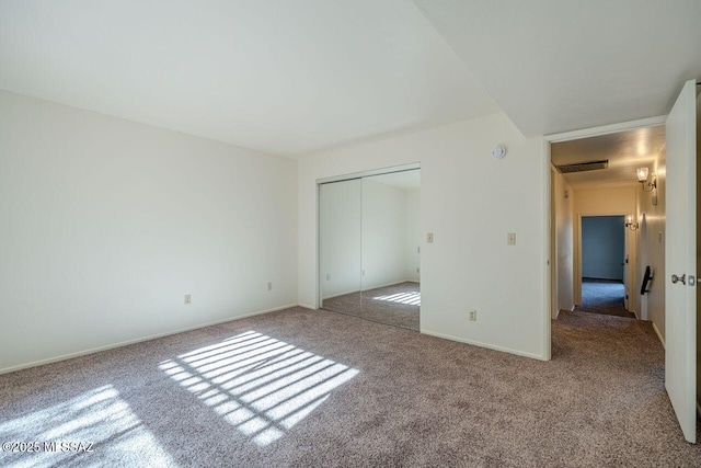 unfurnished bedroom with carpet and a closet