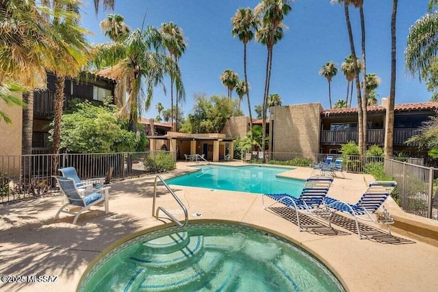 view of pool featuring a hot tub and a patio