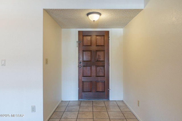 interior space featuring a textured ceiling and light tile patterned flooring