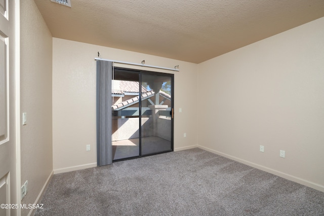 carpeted spare room with a textured ceiling