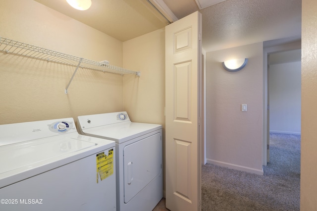 laundry room with separate washer and dryer, dark carpet, and a textured ceiling