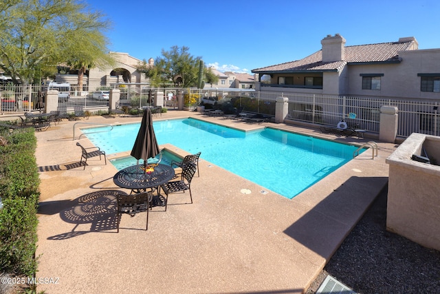 view of swimming pool featuring a patio area