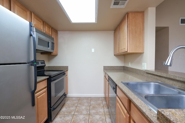 kitchen with stainless steel appliances, sink, and light tile patterned floors