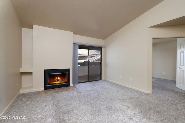 unfurnished living room featuring lofted ceiling and light colored carpet