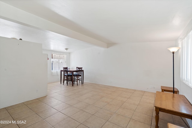 tiled empty room with beamed ceiling